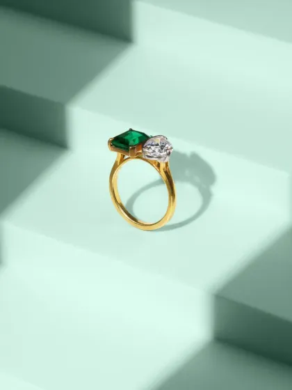 This clean, geometric composition features a stunning emerald and diamond ring against a stepped, mint-green background. Our jewellery photography focuses on sharp details, accurate color, and creative staging to highlight the premium quality of each piece.