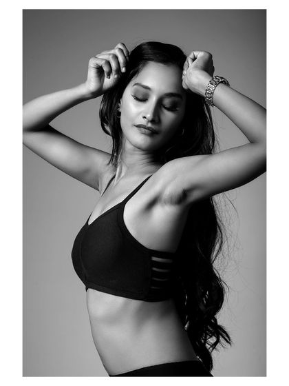 This black and white shot captures a sense of freedom and strength, with the model's hair flowing.