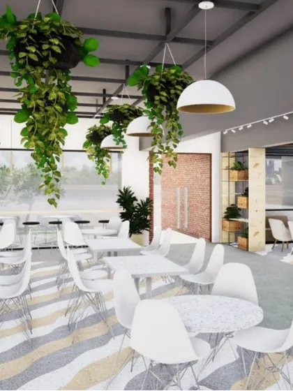 A rendering of the canteen at JIM, Jaipur, showcasing the clean lines, soft grey tones, and abundant greenery. The space is designed to be a relaxing and collaborative environment for students.
