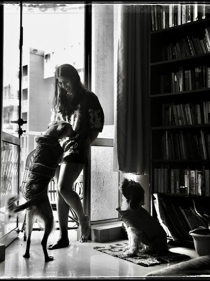 Sara and her dogs, a moment of pure joy and chaos. This 'Doorways' photo is a testament to the love we share with our animal companions.