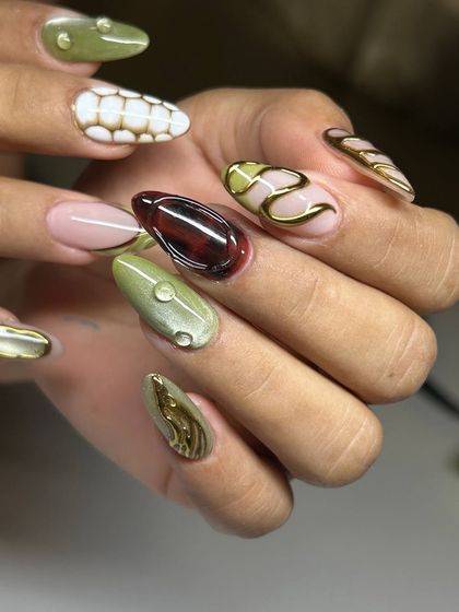 A complete look at a truly extraordinary nail art set. The combination of different colors, textures, and 3D elements like gold swirls and water droplets makes this a wearable piece of art.