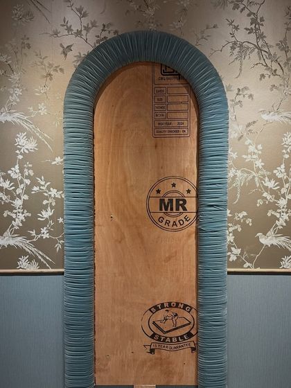 A work-in-progress shot of the pleated mirror from Zone Two. Before the mirror was installed, the custom-built frame was meticulously wrapped in pleated fabric, a challenging process that gives the final piece its soft, sculptural quality.