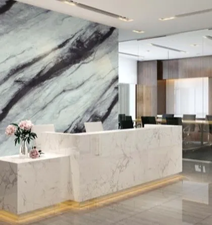 An office reception area featuring a stunning wall and desk clad in our UV Marble Sheets. It creates a professional and high-end first impression.