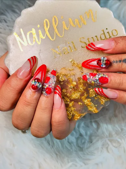 Another angle of these extravagant Karwachauth nails, showing off the detailed gem work and glitter against my custom Naillium coaster.