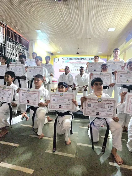 A group of our students proudly displaying their new belts and certificates after a successful grading. Each certificate marks a new level of skill and understanding in their karate training.