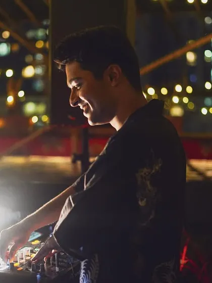 A smile captured mid-set at Raasta. The city lights in the background and the intimate vibe made this a really enjoyable gig.