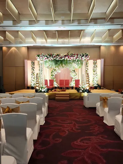 A wide-angle view of our circular arch mandap, showing the complete setup with guest seating. This demonstrates how we design the entire ceremony space for a cohesive look.