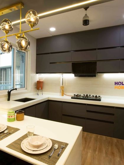 Another view of the open kitchen, showing the breakfast counter and dining setup. This design is perfect for modern families who love to interact while cooking.