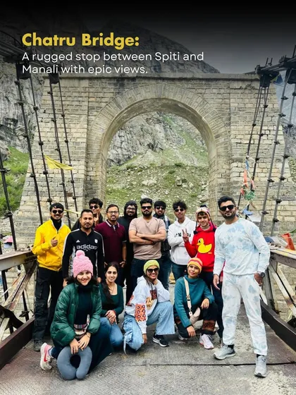 Posing for a group shot on the historic Chatru Bridge. This rugged suspension bridge is a thrilling stop on the road between Spiti and Manali, with epic views all around.