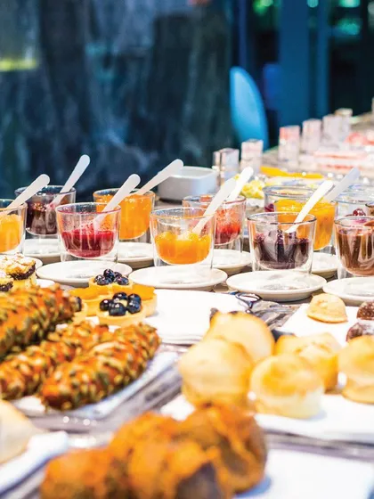 A breakfast spread for a corporate meeting, featuring fresh pastries, jams, and juices. We ensure that every meal, from breakfast to dinner, is crafted with the same attention to quality and detail.