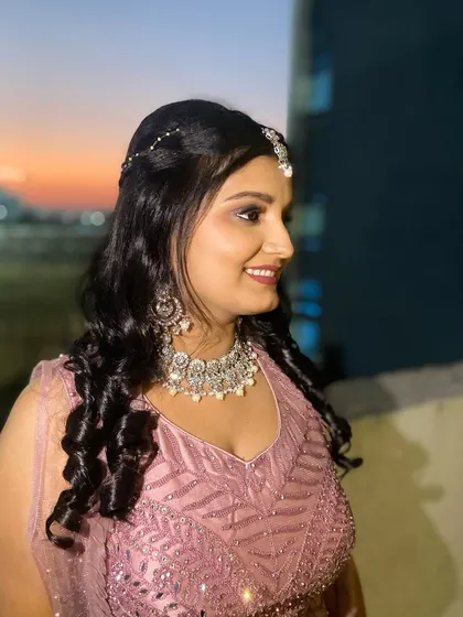 A beautiful shot of the Sangeet bride against the sunset. Her glowing makeup and sparkling jewelry catch the light perfectly.