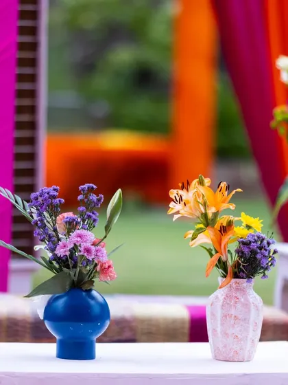 Even the smallest floral arrangements were chosen to match the vibrant theme. These simple bud vases with colorful flowers added a touch of charm to the tables and tied the whole look together.