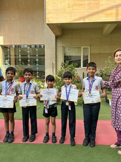 Our Under-8 boys' gymnastics team, who secured 2nd place at an Inter-School Artistic Gymnastics Tournament, pose with their coach and Principal. We are proud of their dedication and excellent performance.