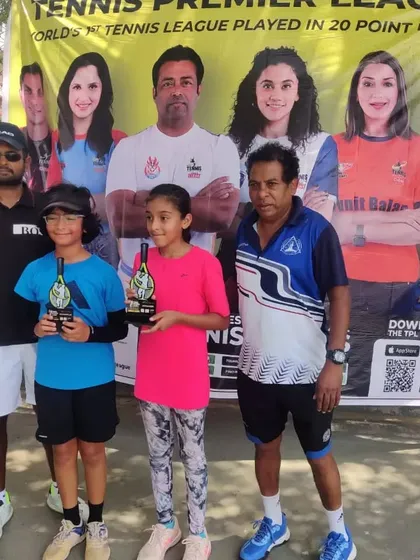 The winners of a junior girls' category at the TPL-ITA Tennis Tournament hold their trophies. We are committed to fostering talent across all age groups and ensure every winner is celebrated at our professionally organized award ceremonies.
