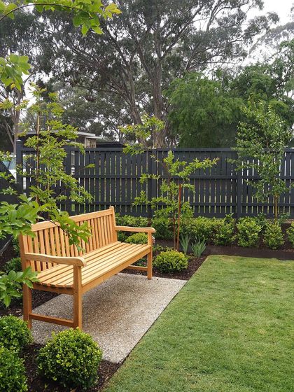 A close-up of the wooden bench, placed on a gravel pad. This detail shows how we combine different materials like turf, gravel, and wood to create texture and define zones.