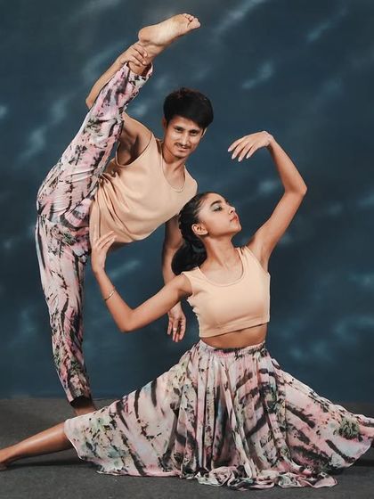 A stunning partner pose from 'Synchronicity', showcasing incredible flexibility and trust between dancers. These are the moments that leave audiences spellbound.