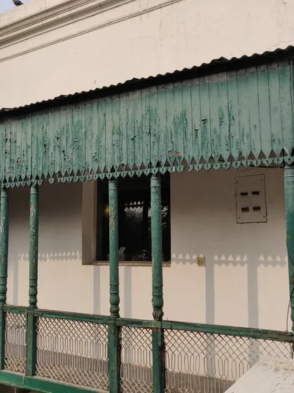 Another view of the dilapidated balcony before we began our work, highlighting the faded paint and weathered wood.