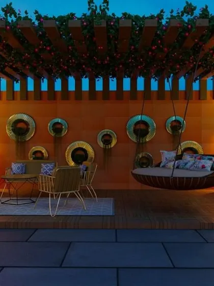 This terrace design showcases a perfect evening ambiance. We used a combination of a creeper-laden pergola, illuminated planters, and a comfortable swing to create a cozy and stylish space for relaxation.