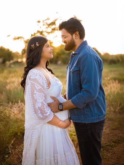 The connection between two people about to become parents is so special. This photo captures that bond with a simple, loving look against a beautiful sunset backdrop.