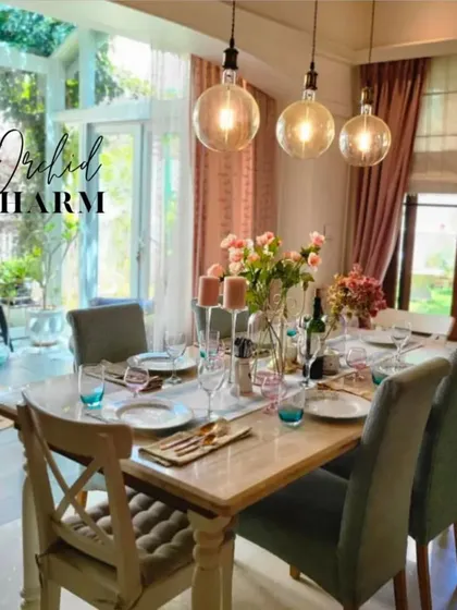 We created a bright, charming dining area perfect for family gatherings. The large windows, rustic table, and floral centerpiece give this space a welcoming, cottage-core feel.