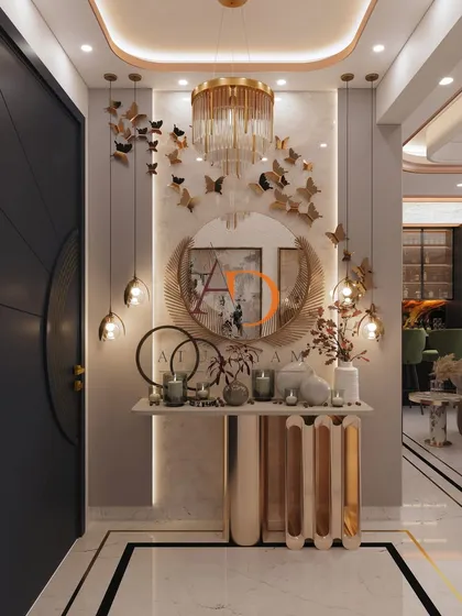 A close-up of the foyer console table, adorned with candles, a round mirror, and a cascade of golden butterflies on the wall.