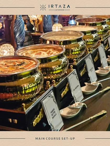 A full lineup of my Indian main courses, including Paneer Butter Masala and Dal Makhani, each clearly labeled. The row of shining golden pots creates an impressive and appetizing display.