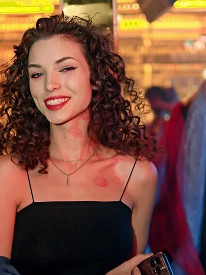 A guest with lipstick kisses on her neck, fully embracing the V-Day theme.