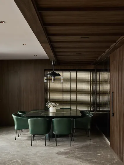 The dining room in Project Acropolis is defined by this 8-seater square dining table made from Avocado Green Quartzite. The floating design and rounded edges give this substantial piece a sense of lightness, while the deep green leather chairs complete the look.