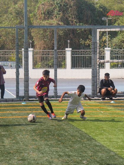 Two young players challenge for the ball, showing the grit and determination of our athletes.