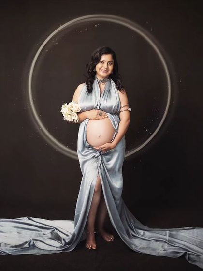 Explore our packages to get your maternity session done in stylish fabric drapes, like this beautiful silver-blue gown.