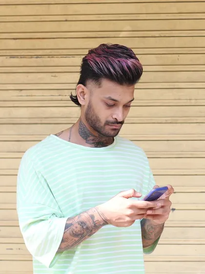 We can get creative with it. For my homeboy here, we did a modern mullet with a pop of pink and purple on top. This shows how you can combine a sharp haircut with a bold fashion color for a unique style.