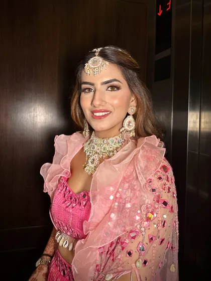 Carnival and Mehendi ready! This look is all about fun and color, with a bright pink outfit and makeup that features glowing skin and a radiant smile.