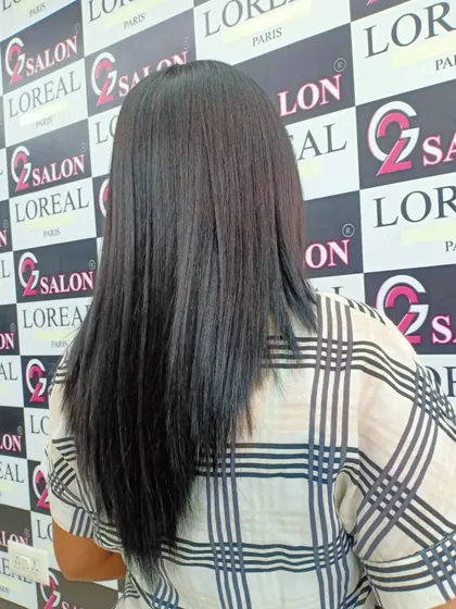 This client's hair is now sleek and straight with a healthy shine after her appointment. A simple U-cut adds shape to the final look.