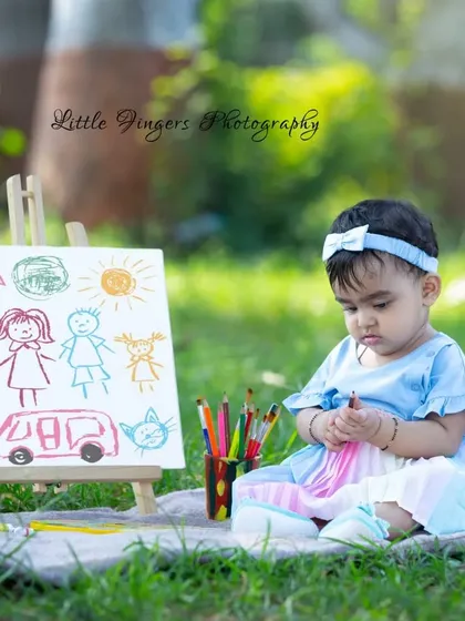 This little angel is contemplating her next color choice for her family portrait drawing.