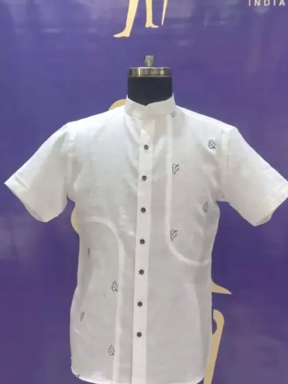 A unique custom white half-sleeve shirt with leaf embroidery and pocket details. It's a great way to add a personal touch to a classic white shirt.