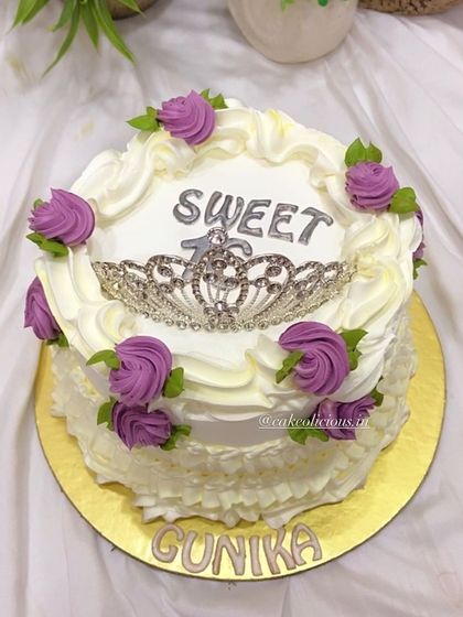 A royal vintage cake for a Sweet 16 celebration. This design features delicate piped ruffles, purple roses, and a sparkling tiara on top for a truly regal look.