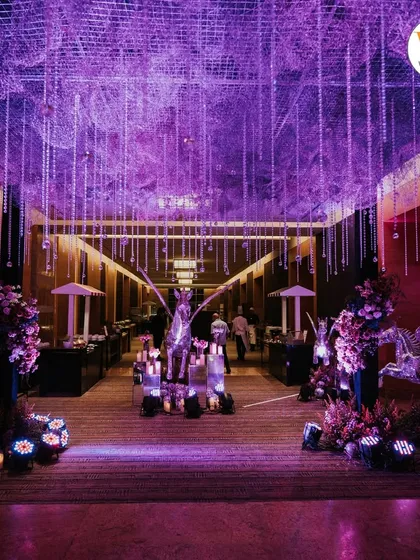 We create immersive experiences for your guests from the moment they arrive. This grand entrance for a celestial-themed Sangeet featured purple uplighting, crystal-clear pegasus statues, and a ceiling of hanging crystals to set a magical mood.