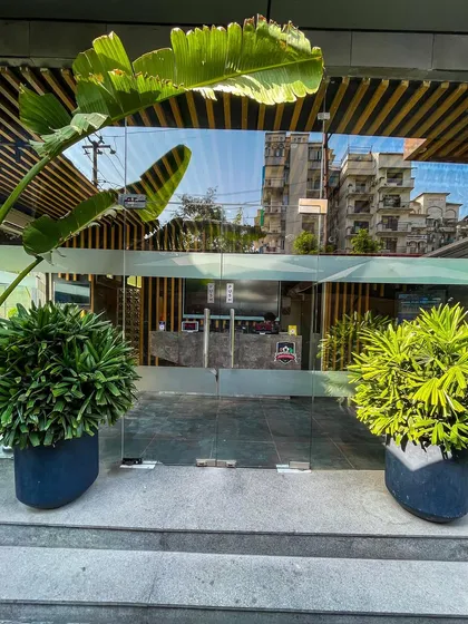 The welcoming entrance to our studio, surrounded by greenery to create a sense of calm before your workout.