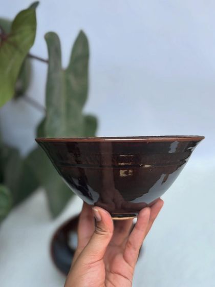 Our signature Tenmoku glazed ramen bowl with a splash of Chun. The deep brown and light blue glazes create a stunning, galaxy-like effect inside the bowl.