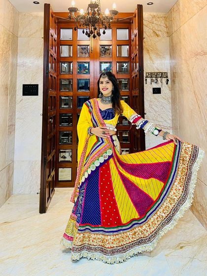 A full view of our custom-designed multi-color Navratri lehenga, showing how the vibrant panels create a stunning effect with every movement.