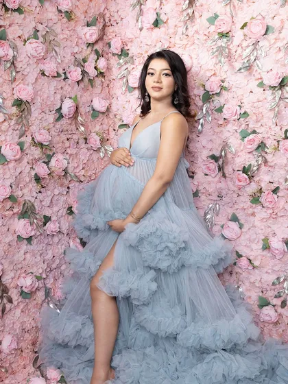 Handcrafting my sets and making you feel beautiful is what I love. This stunning floral wall and voluminous blue gown create a truly magical portrait.