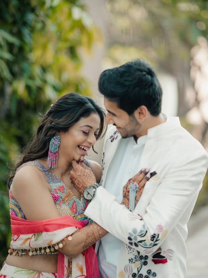 A playful and affectionate moment between a couple in colorful traditional wear. The genuine laughter in this photo is what I strive to capture in every shoot.