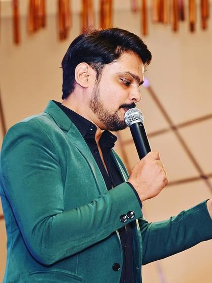 Reading from my notes to introduce the next segment. While I am highly interactive, I am also meticulously prepared to ensure the event schedule is followed.