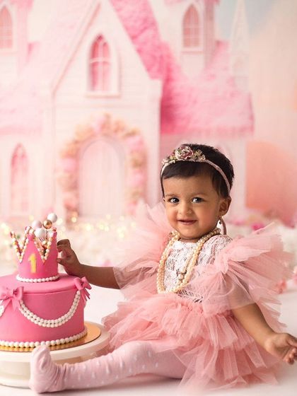 A true princess celebrating her first birthday in her very own castle. This little darling's happy eyes say it all, and her pink tulle dress was just perfect for the theme.