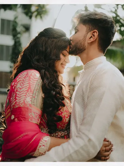 A sweet moment captured during an engagement shoot. The bride's makeup is fresh and radiant, enhancing her happy glow.