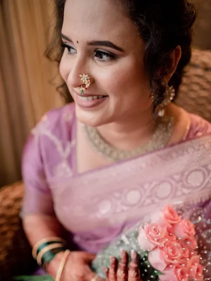 A close-up of the bride, her smile radiant. The makeup is fresh and light, perfect for an engagement ceremony.