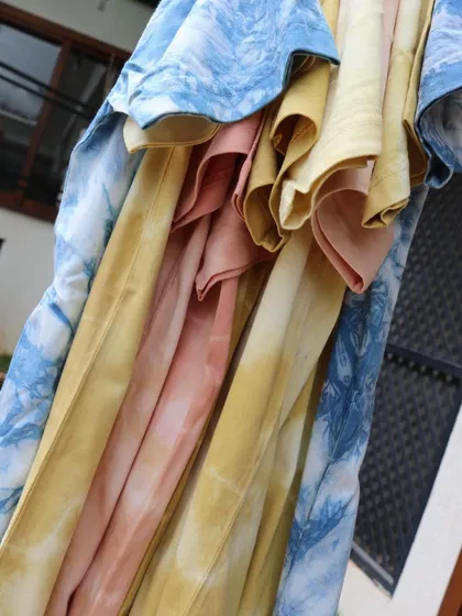 Another artistic shot of the naturally dyed tees. The soft, flowing fabric and the unique patterns make each one a desirable piece of slow fashion.