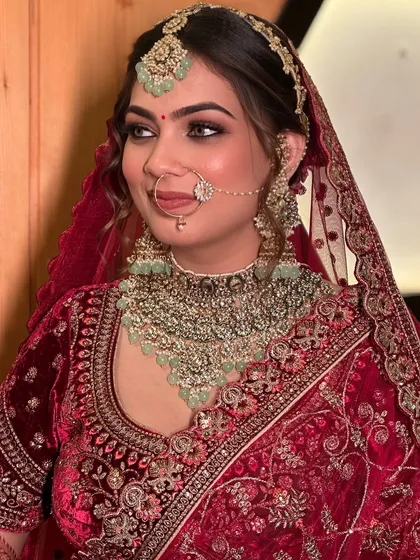 This side profile showcases the complete harmony of the bridal makeup and hair. The elegant updo and flawless makeup ensure she looks stunning from every angle.