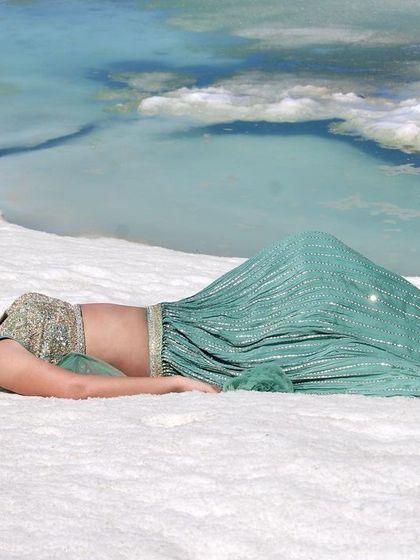 A final wide shot capturing the breathtaking scenery and the beautiful outfit.