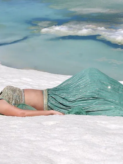 A final wide shot capturing the breathtaking scenery and the beautiful outfit.